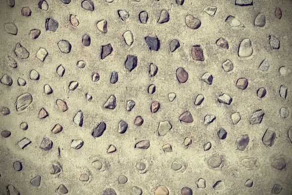 Piedras reales en muro de cemento, fondo abstracto natural . — Foto de Stock