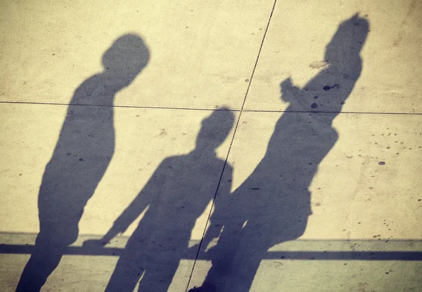 Vintage toned shadows of three people, concept picture. — Stock Photo, Image