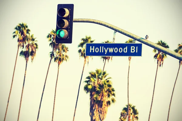 Cross processed Hollywood sign and traffic lights.