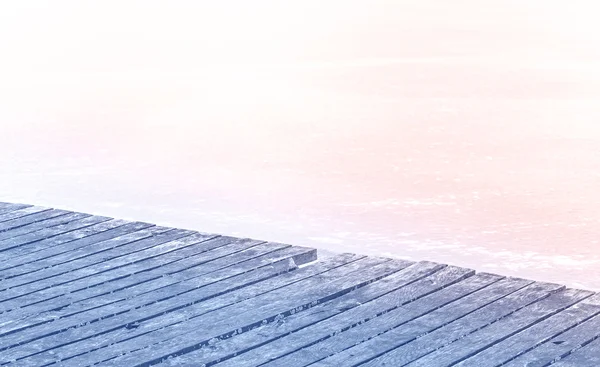 Rose quartz and serenity colors stylized wooden pier on frozen l — Stock Photo, Image