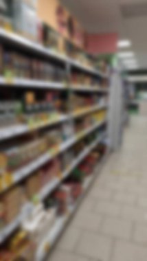 Blurred background of shelves inside the supermarket. Sale of goods to the buyer in the store. assortment.