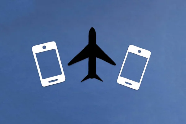 The plane is black, two phones are white on a blue background. Journey. International relations.