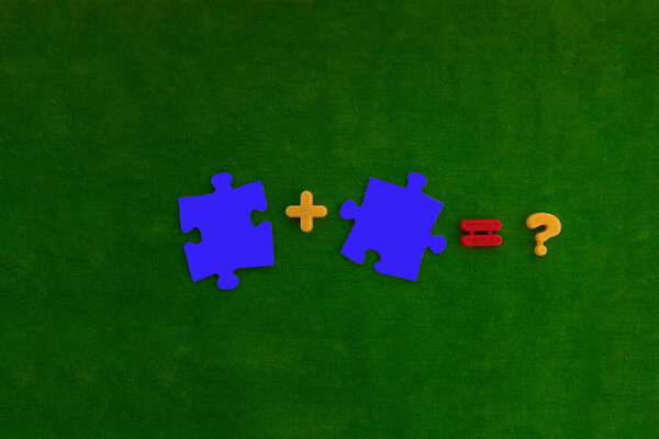 Two puzzles in blue, plus sign, equal, question on a green background. The concept of connection, interaction.