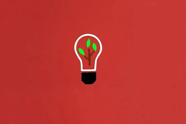 Electric light bulb, plant sprout on a red background. Creative ideas. the beginning of a new business, project.