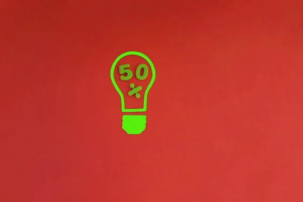 Electric light bulb, 50 % green on red background. Half of the solution. Thinking, business ideas.