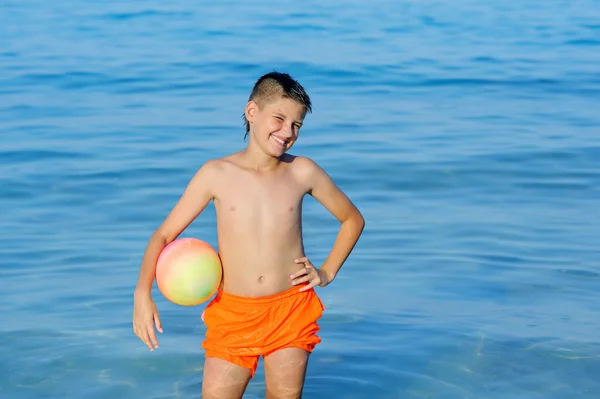 Garçon jouer à la balle dans une belle mer tropicale — Photo