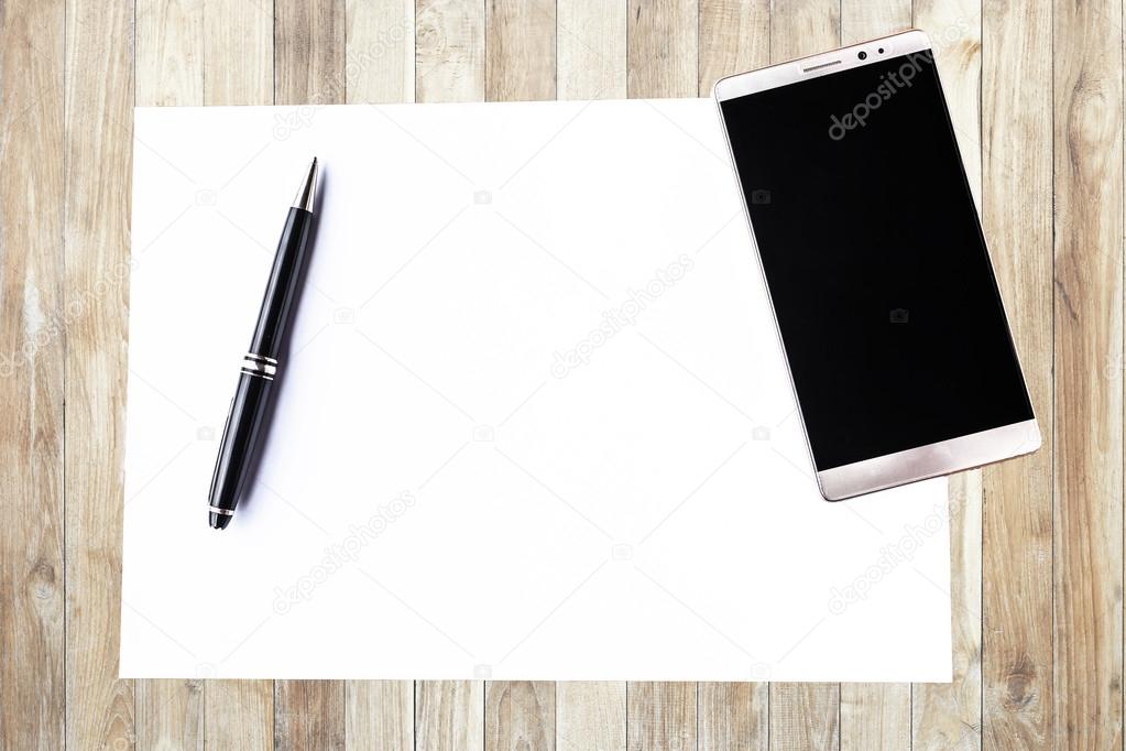 Blank paper with pen and smartphone on wood table concept and Id