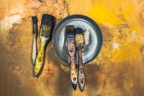 Pincéis de pintura a óleo sobre fundo pintado de madeira — Fotografia de Stock