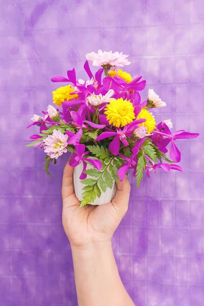 Hand holding bouquet of chrysanthemum and orchid flowers isolate — Stock Photo, Image
