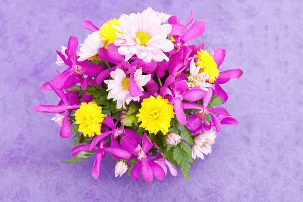 Bouquet of chrysanthemum and orchid flowers isolated on purple v — Stock Photo, Image