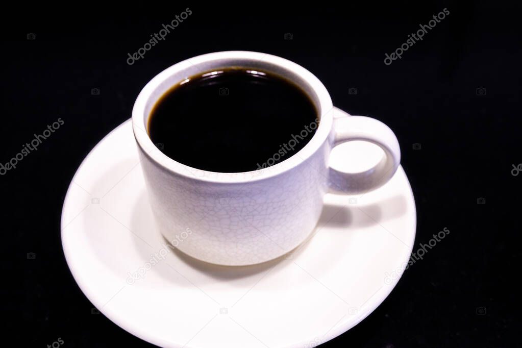 White Coffee Cup with Americano black coffee on black.