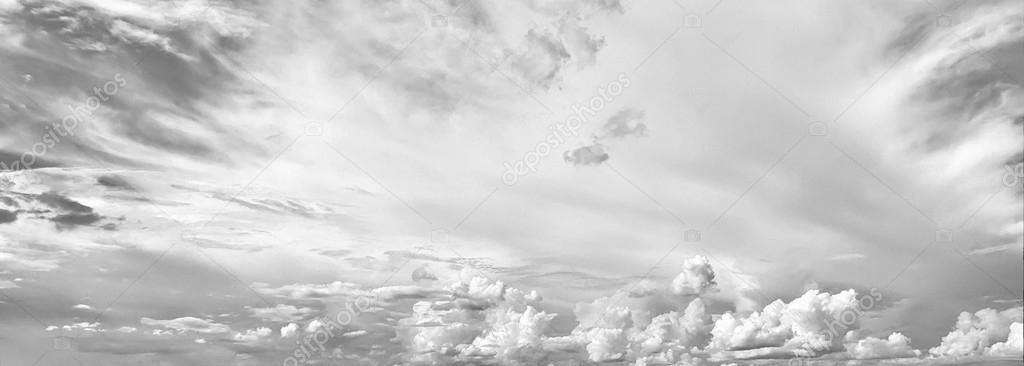 black and white sky background with tiny clouds and cityscape on
