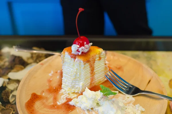Strawberry cheesecake and wipcream on wood dish — Stock Photo, Image