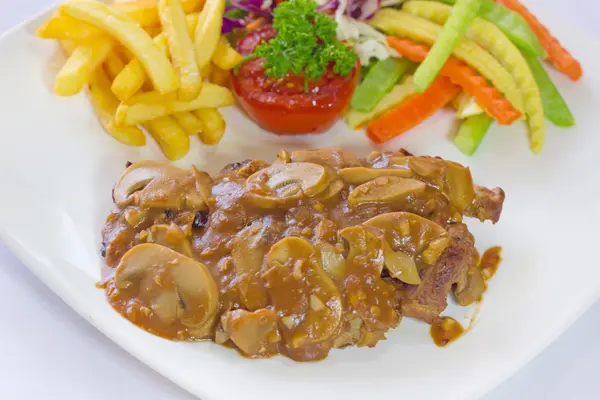 Beef steak with sauteed mushrooms and onions, french fries and v — Stock Photo, Image