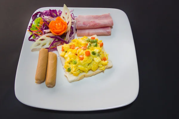 Plate of breakfast with fried eggs, bacon and toasts isolated ba — Stock Photo, Image