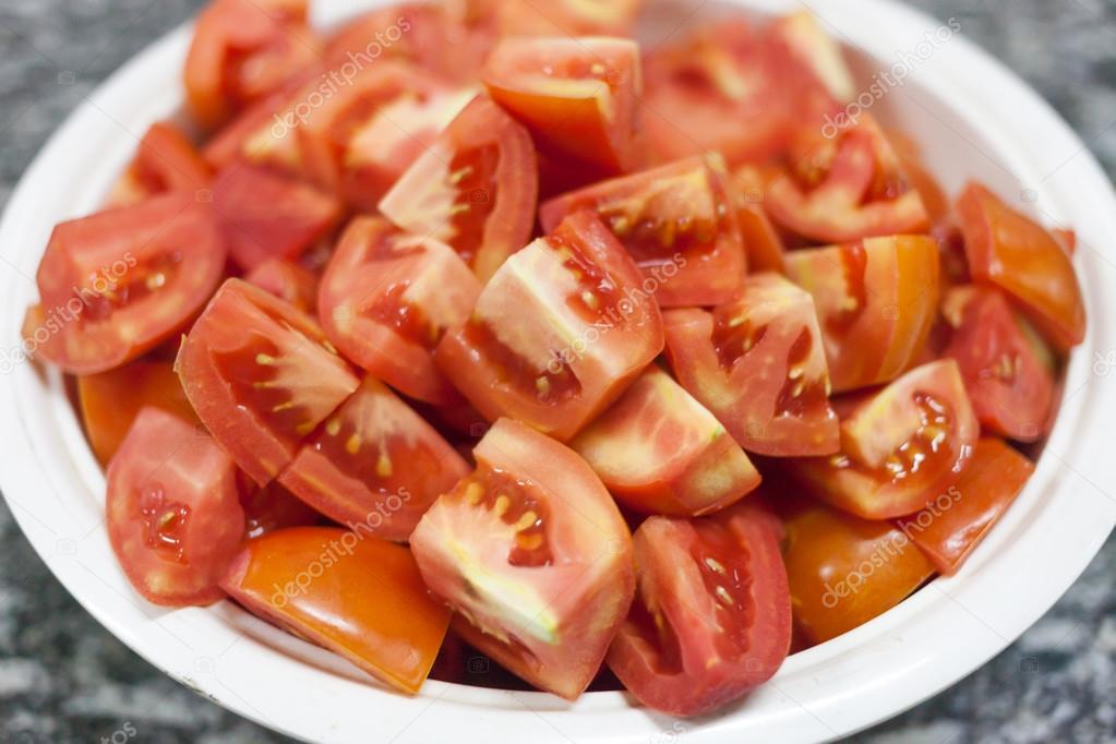Red Tomato fresh slices in dish on table