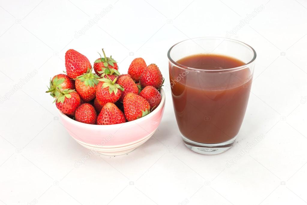Small white bowl filled with red strawberries 