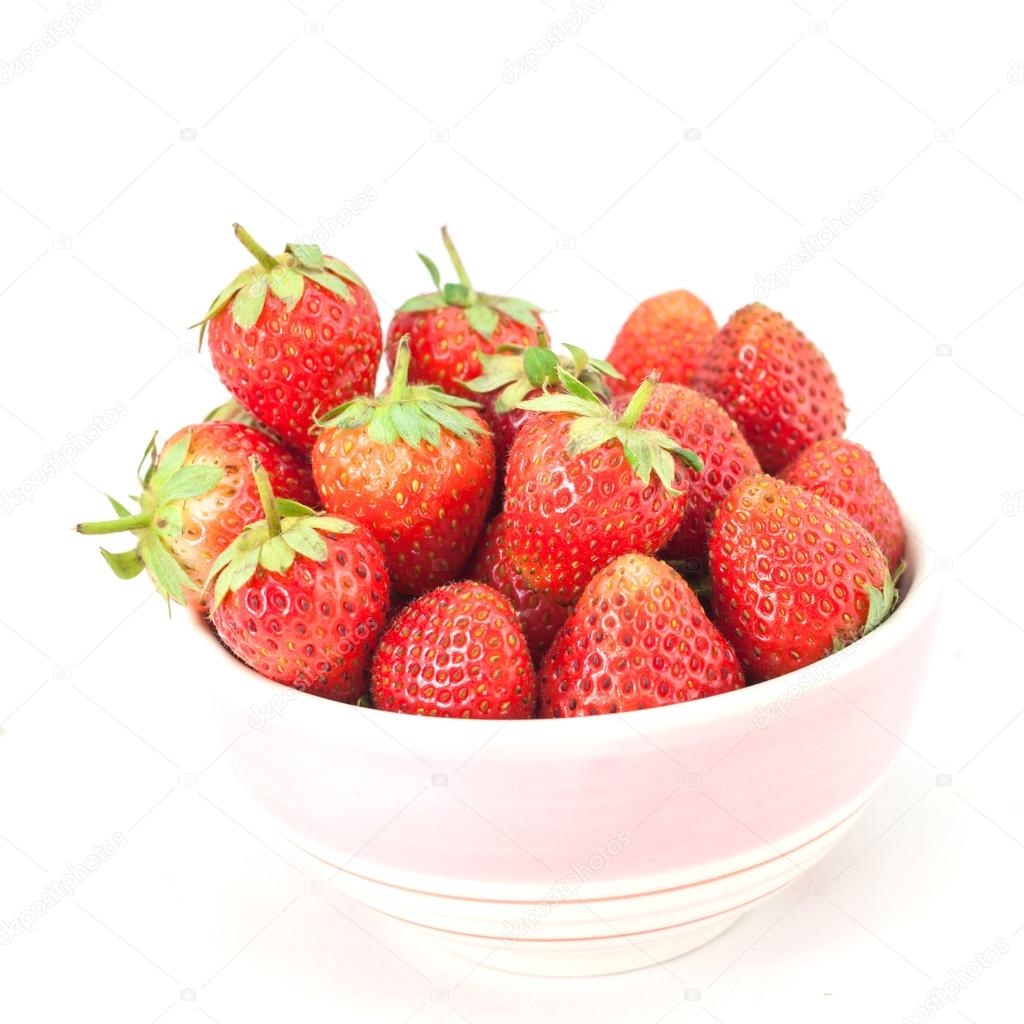 Small white bowl filled with red strawberries 