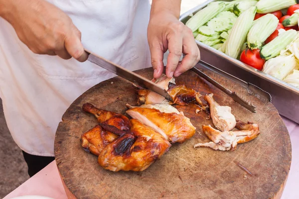 Chef are using Kitchen knife chicken grilled on wood block — Stock Photo, Image