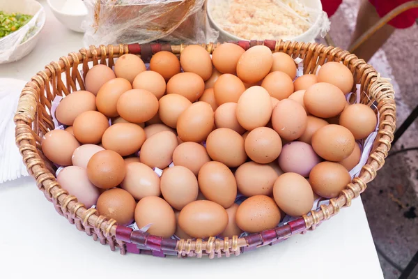 Chicken eggs in a basket isolate on white background — Stock Photo, Image