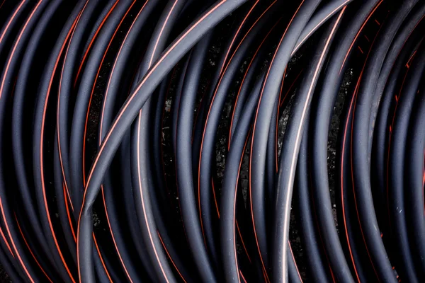 Abstraktní pozadí kroucený kabel červené a černé barvy čar — Stock fotografie
