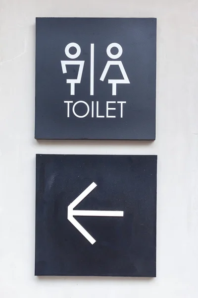 Unisex restroom or Toilet and arrow sign on  concrete wall style — Stock Photo, Image