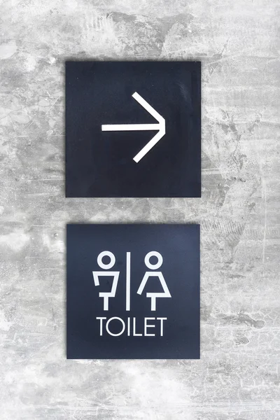 Unisex restroom or Toilet and arrow sign on  concrete wall style — Stock Photo, Image