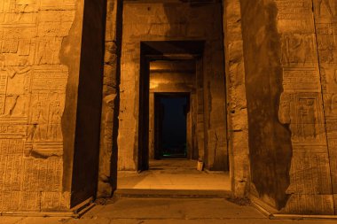 Beautiful columns of the Kom Ombo temple at night illuminated, the temple dedicated to the gods Sobek and Horus. Town of Kom Ombo near Aswer, Egypt clipart