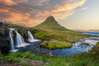 The beautiful sunset at Kirkjufell waterfall in Iceland clipart
