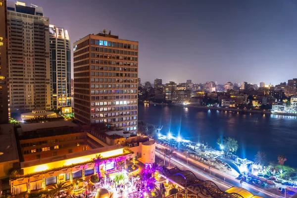 Aerial view of the city of Cairo at night along the river Nile. Skyline of the African city of Egypt