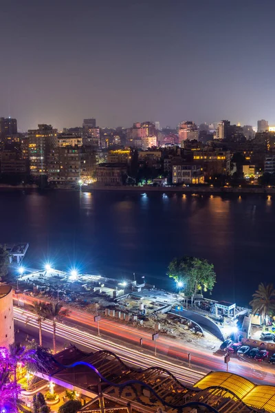 Aerial view of the city of Cairo at night along the river Nile. Skyline of the African city of Egypt