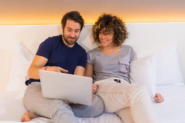 Lifestyle Young Caucasian Couple Pajamas Top Hugging Pajamas Bed Looking — Stock Photo, Image