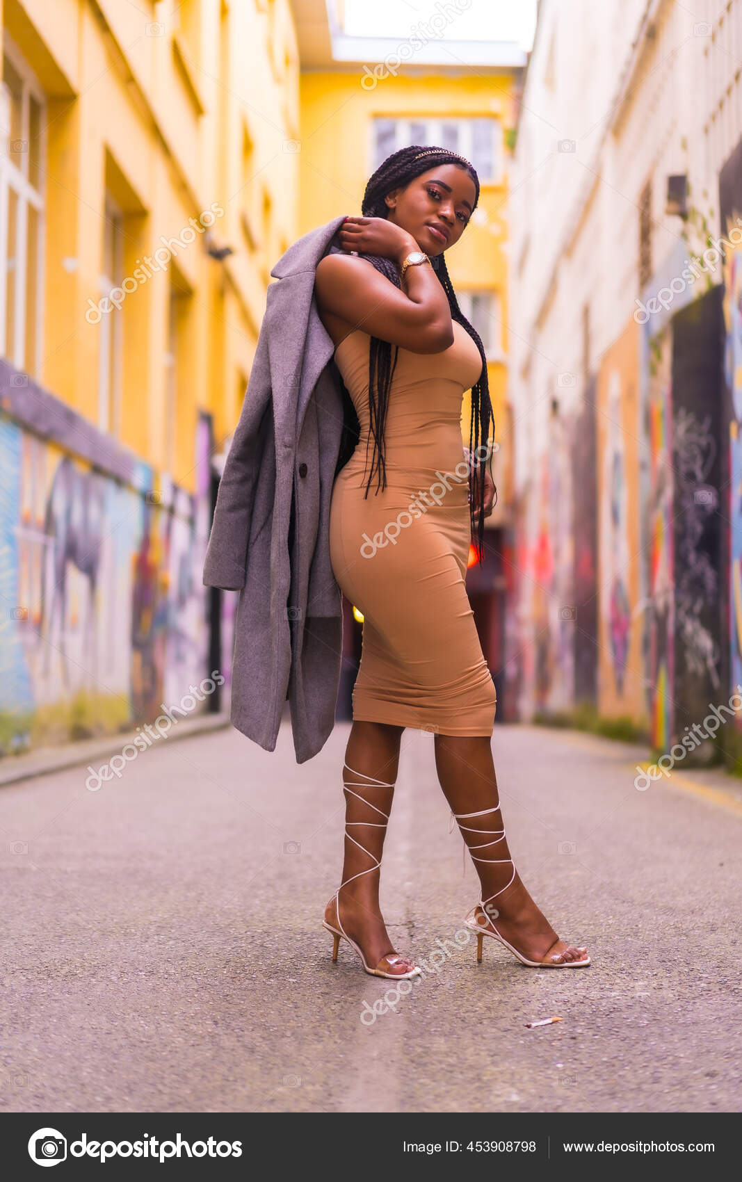 Trendy urban style with a black African girl in a cream colored dress on a  city street Stock Photo by Unai82
