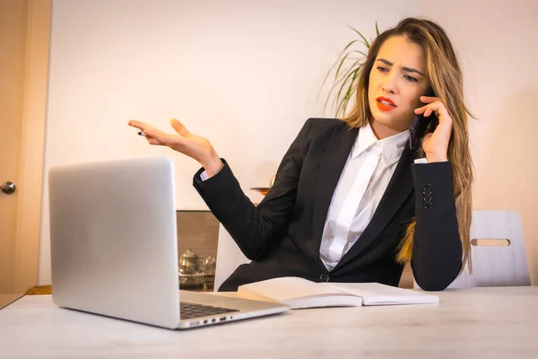 Difficulties of teleworking at home during the coronavirus pandemic, young blonde Caucasian woman with a coffee working with the computer