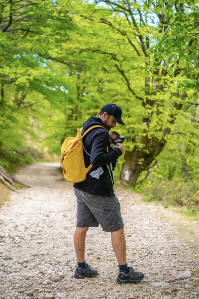 Young Father Placing Newborn Child Well Backpack Path Forest Heading — Stock Photo, Image