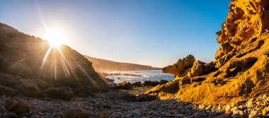San Sebastian yakınlarındaki Pasajes kasabasındaki Jaizkibel dağındaki taş koyunda gün batımı. Bask Ülkesi