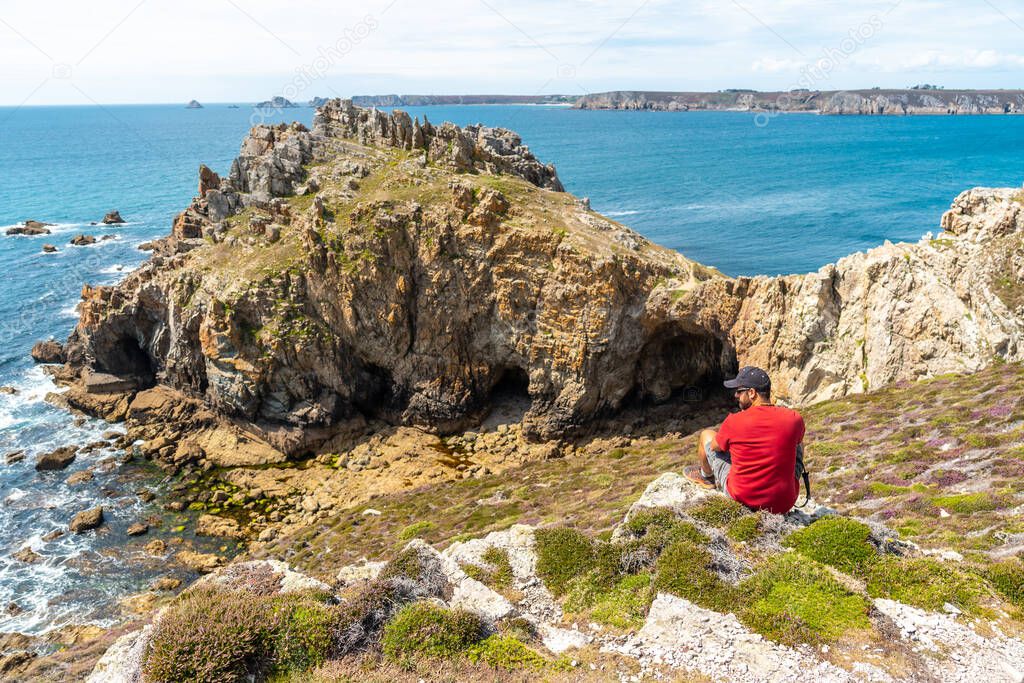 A young man enjoying the summer at Le Chateau de Dinan on the Crozon Peninsula in French Brittany, France