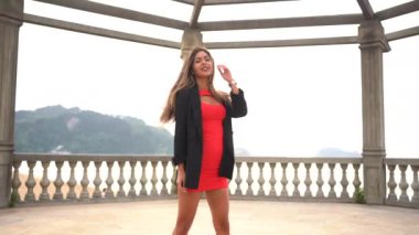 Yaşam tarzı, Kafkas esmer, kırmızı elbiseli kız deniz kenarında tatilin tadını çıkarıyor.