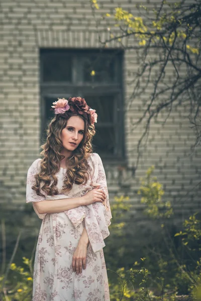 Joven chica bonita está posando con flores —  Fotos de Stock