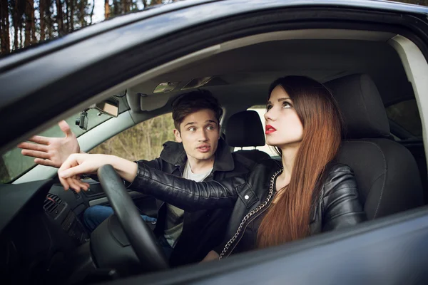 Couple quarrel in the car,  woman behind wheel of  car — Stock Photo, Image