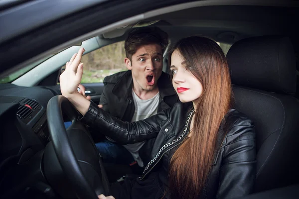 Couple quarrel in the car,  woman behind wheel of  car — Stock Photo, Image