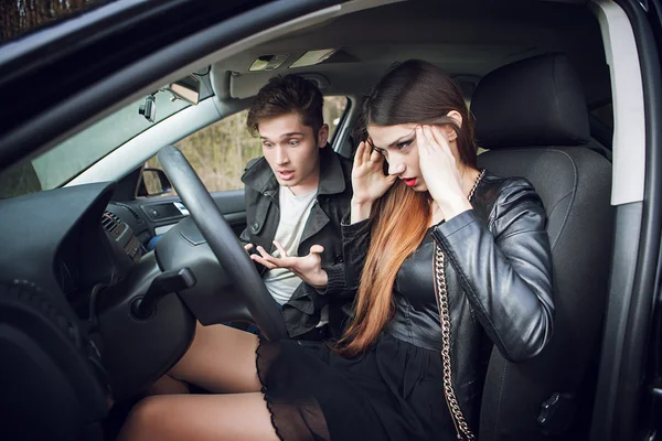 Couple quarrel in the car,  woman behind wheel of  car — Stock Photo, Image
