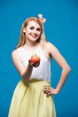 girl style of pin-up,  plays with apple, healthy lifestyle