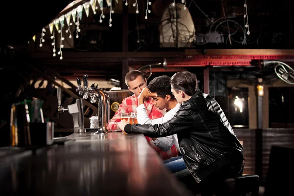 Přátelé pít pivo a trávit čas spolu v baru. — Stock fotografie