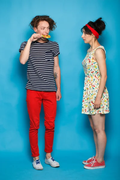 Man and woman fighting for a sweets. — Stock Photo, Image