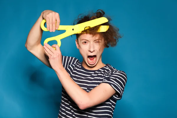 funny guy cuts his hair with scissors