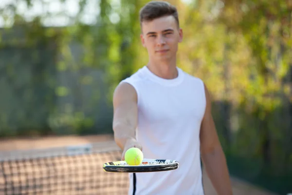 Young man play tennis outdoor on orange  court — Stock Photo, Image