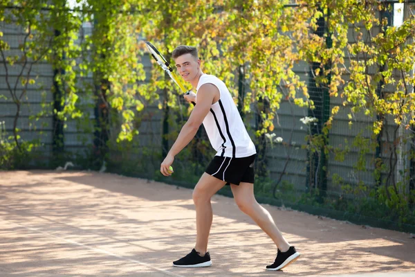 Young man play tennis outdoor on orange  court — Stock Photo, Image