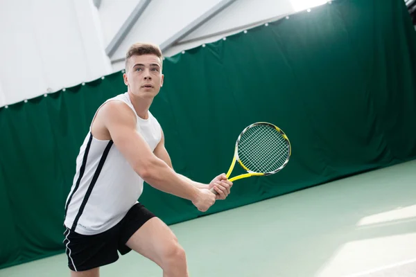 Young man play tennis outdoor on orange  court — Stock Photo, Image