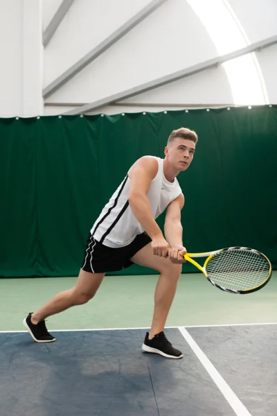 Young man play tennis outdoor on orange  court — Stock Photo, Image